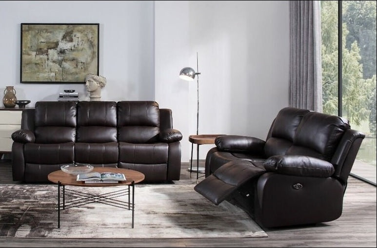 A dark brown leather recliner chair with the footrest extended, shown in a modern living room.