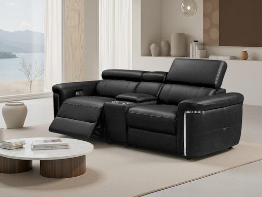 Black leather sectional sofa in a modern living room with a view of a lake.