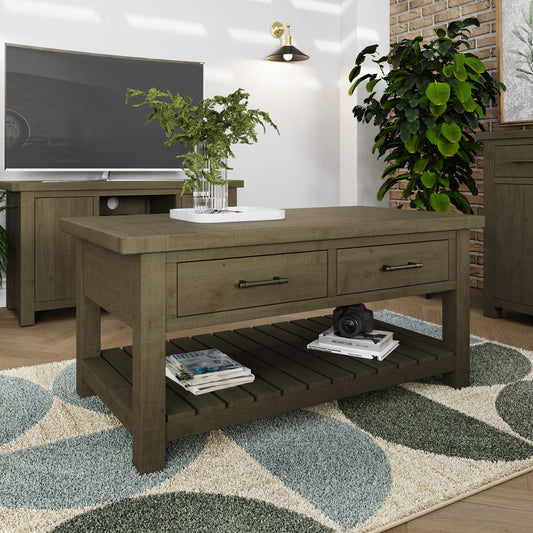 Wooden coffee table in a living room setting with a TV and plants.