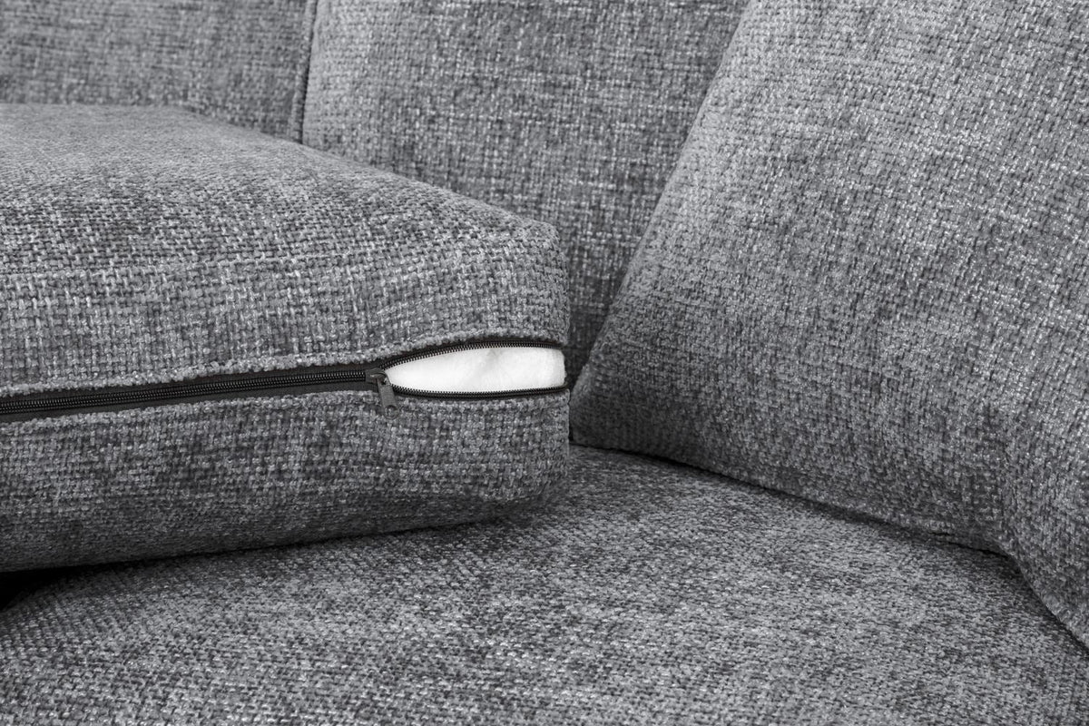 Gray fabric sofa with a close-up of a seam and zipper.