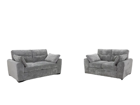 A gray upholstered loveseat and matching armchair shown side by side on a plain white background.