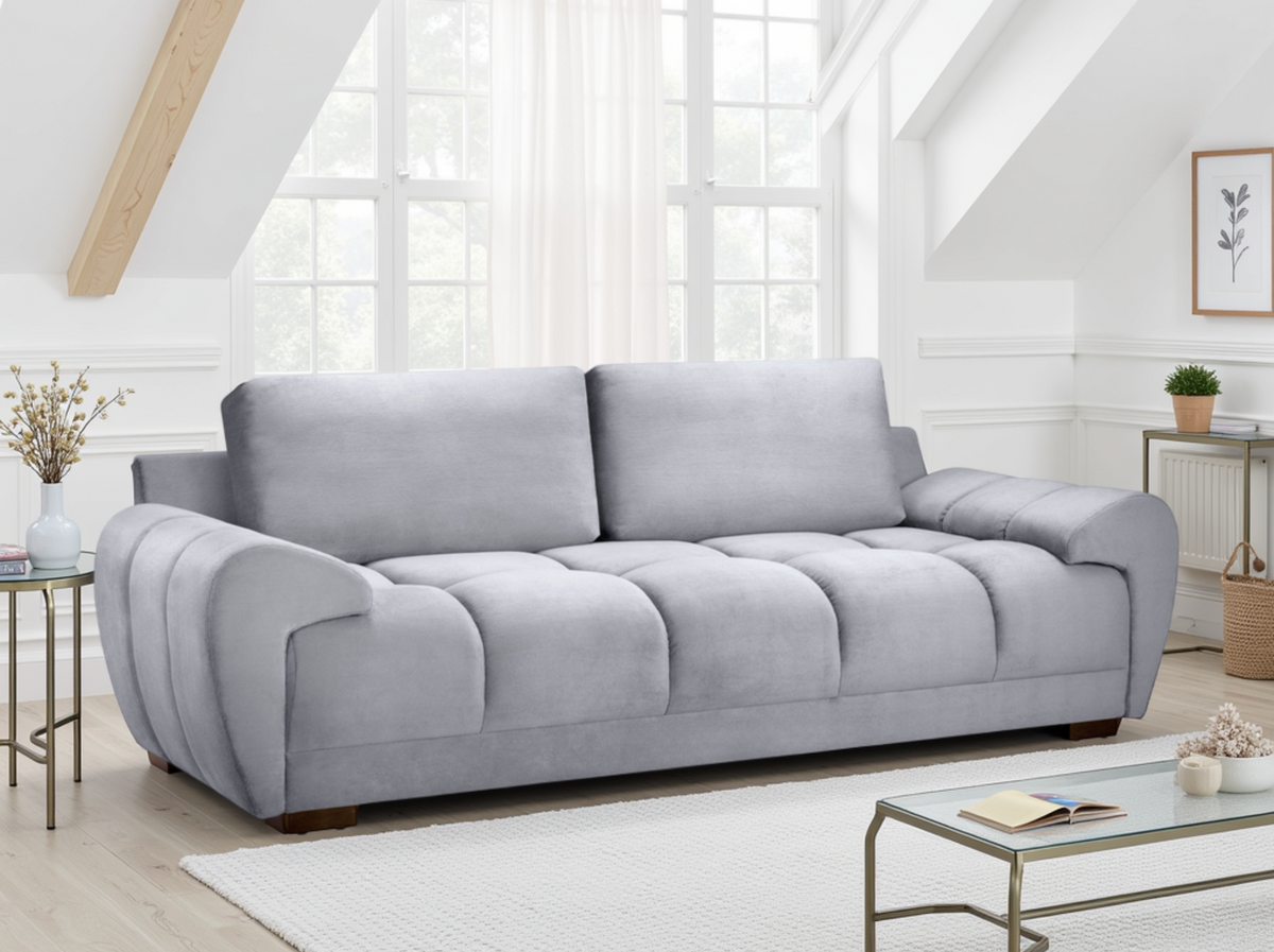 Gray sofa in a bright living room with large windows.