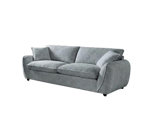 A modern gray fabric sofa with two matching throw pillows, shown from a three-quarter angle against a plain white background.