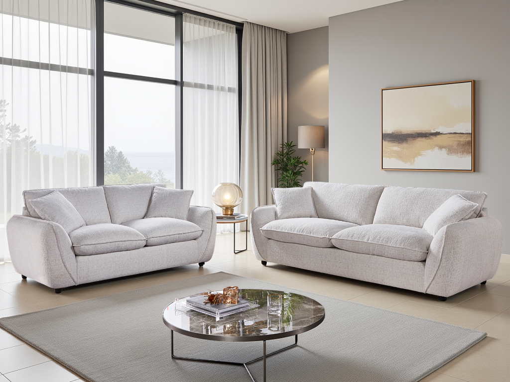Modern living room with light beige sofas, a round coffee table, and decorative elements.