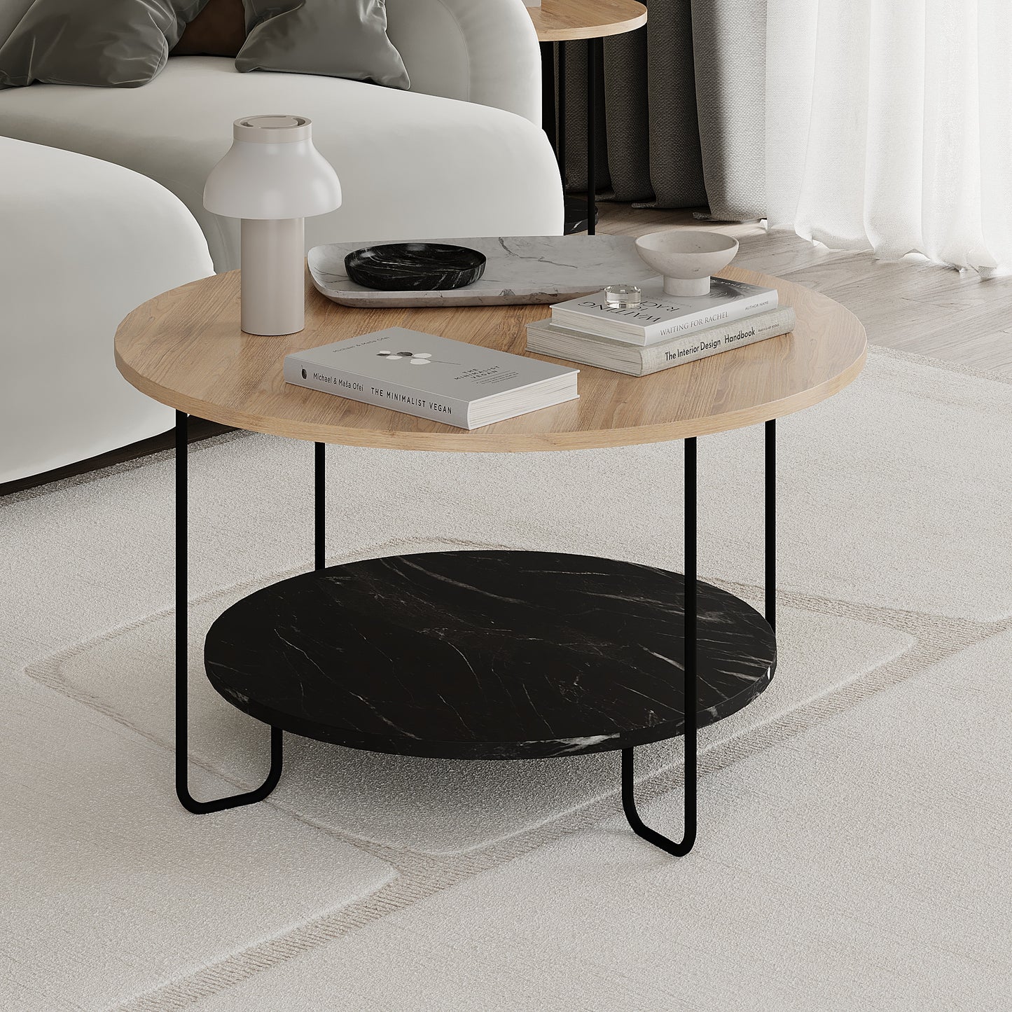 Round coffee table with wooden top and black marble shelf in a living room setting.