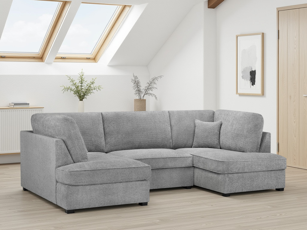 Gray sectional sofa in a room with skylights and minimal decor.