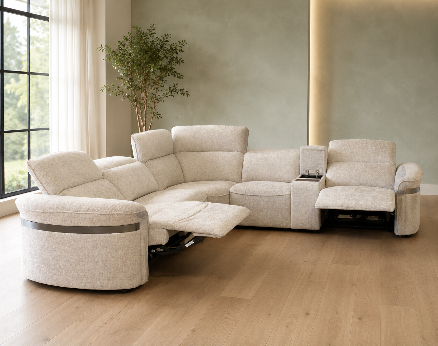 A modern curved corner sectional sofa in light beige fabric, shown in a staged living room. The sofa includes a reclining section with the footrest extended and a chaise lounge.