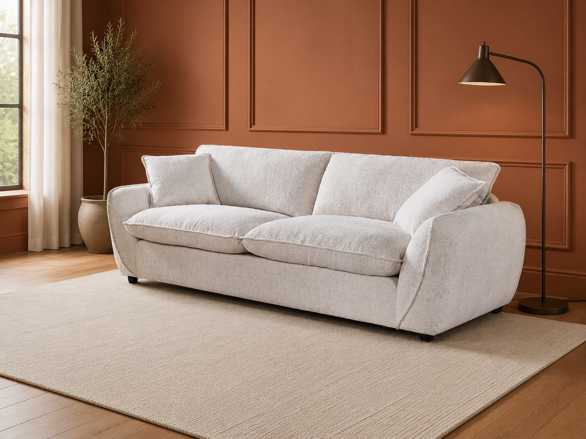 A light beige upholstered loveseat with two matching throw pillows in a modern living room.