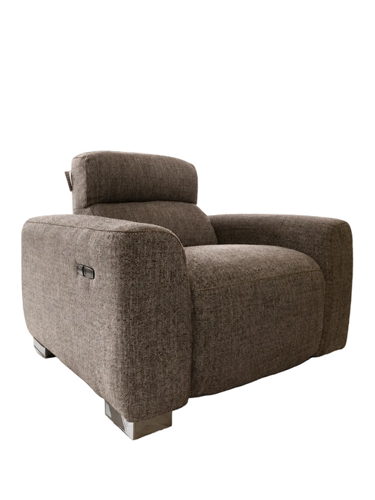 A modern low-profile armchair upholstered in textured taupe-brown fabric, featuring a built-in headrest and a small side control panel on the outer arm, set against a plain white background.