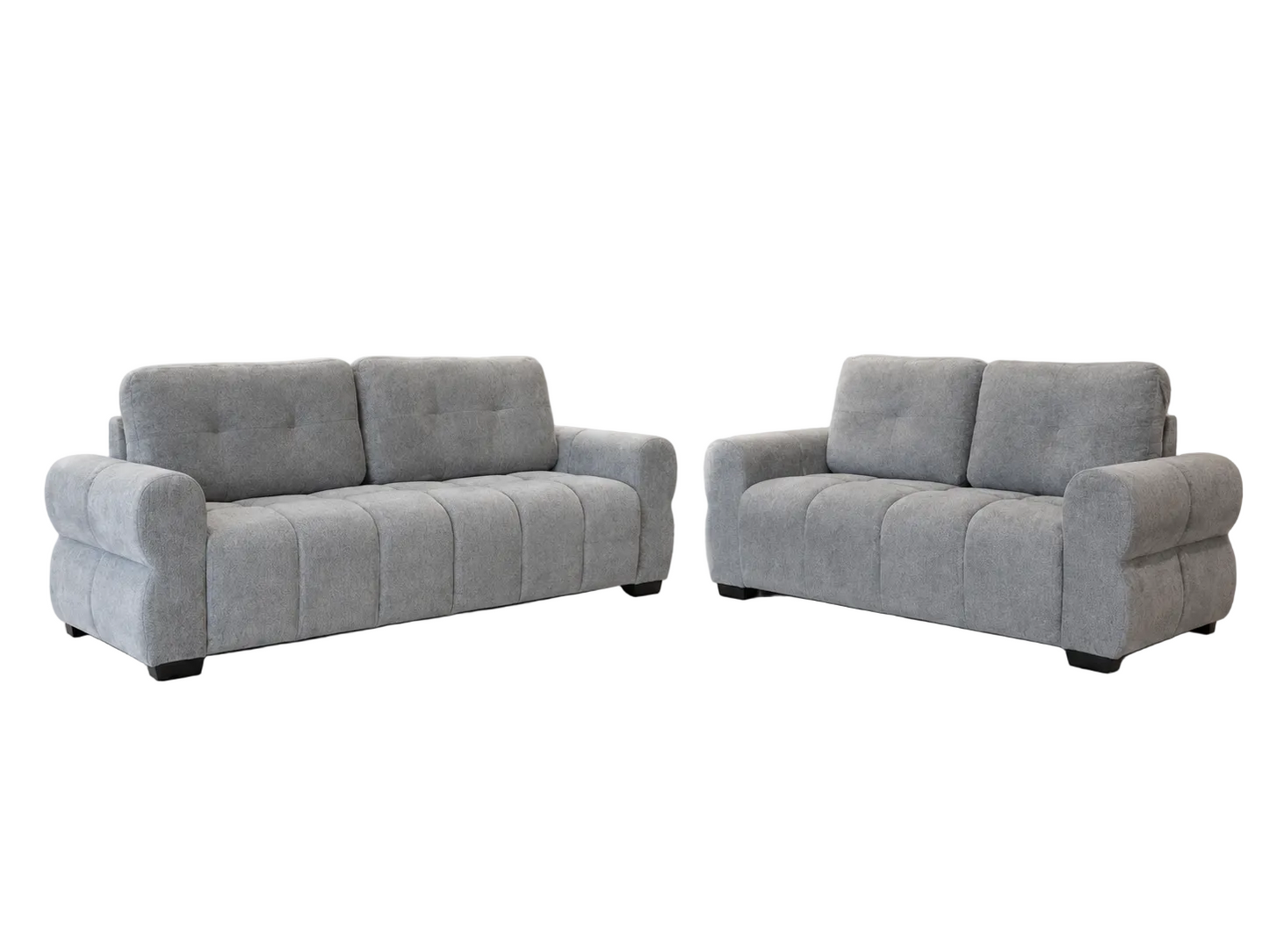A light gray upholstered loveseat and matching sofa set with tufted back cushions and rounded arms, shown on a plain white background.
