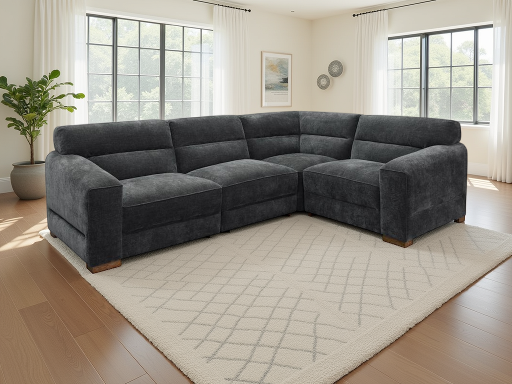 Charcoal sectional sofa in a living room with large windows and a rug.