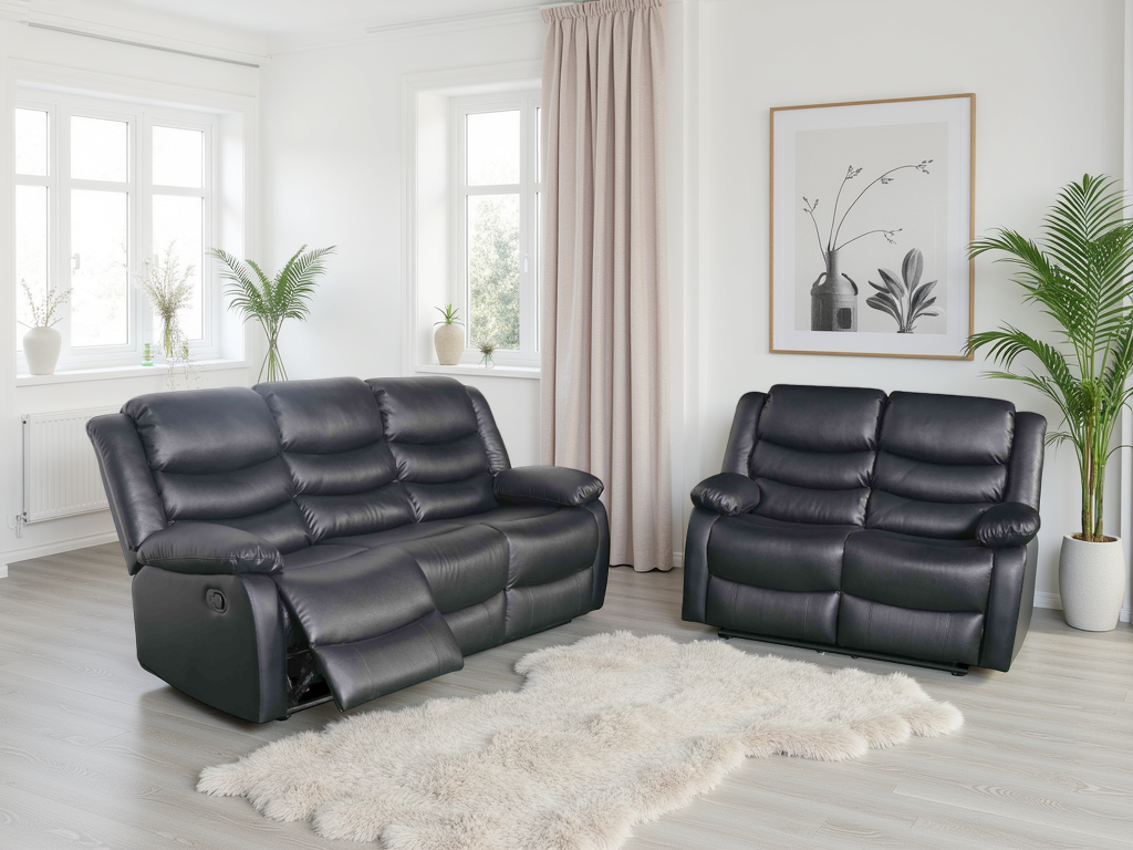 Black leather recliner sofa set in a living room with plants and decor.