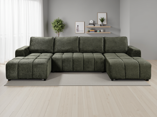 Green sectional sofa in a living room setting with decor elements.