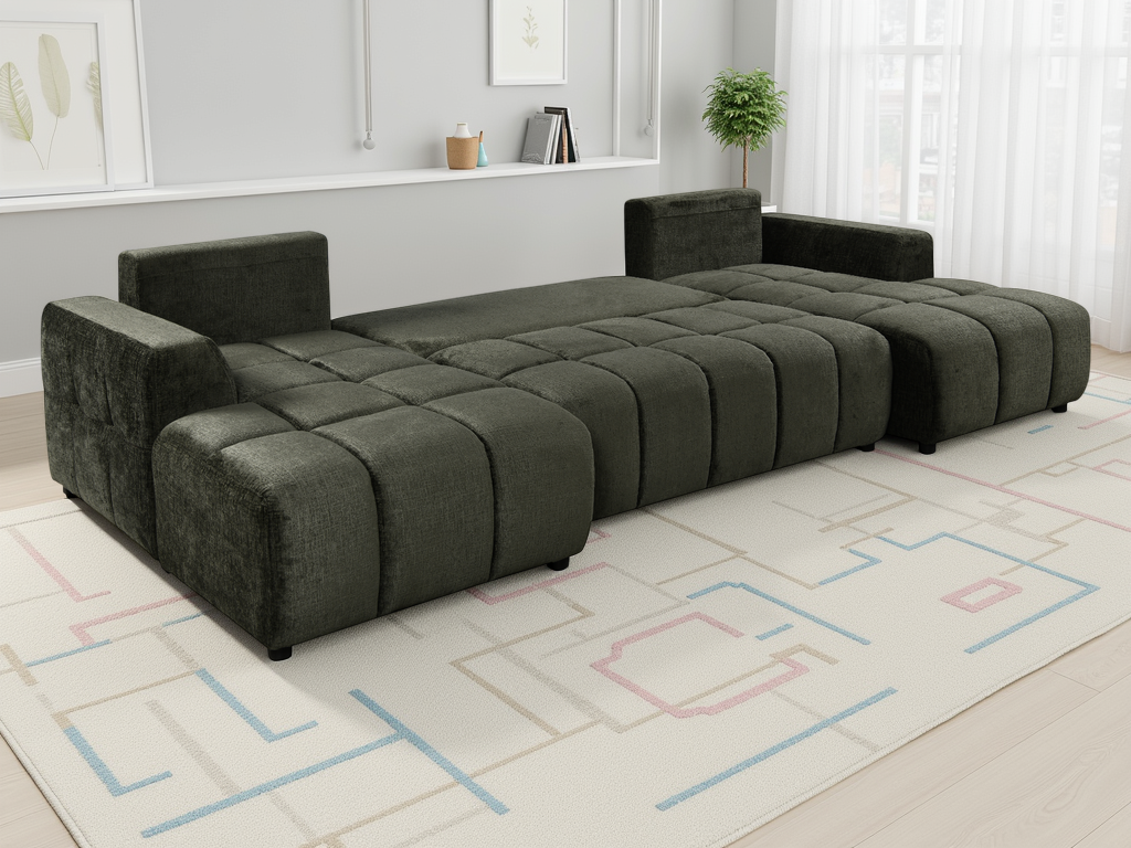Modular green sofa in a living room setting with a rug and wall art.