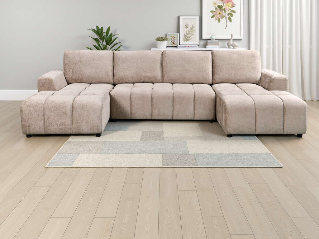 Beige sectional sofa in a living room with a rug and decorative items.
