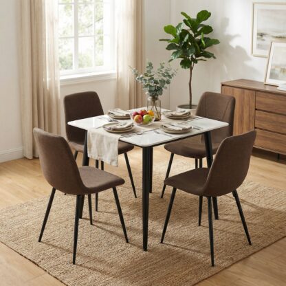 Dining room with a table set for four, chairs, and decor elements.