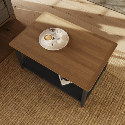 Wooden table with a plate of food and a glass on a textured floor.