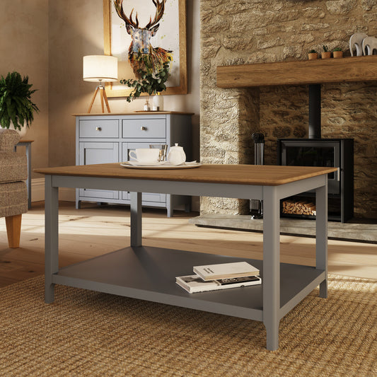 Wooden dining table with a gray base in a cozy living room setting.