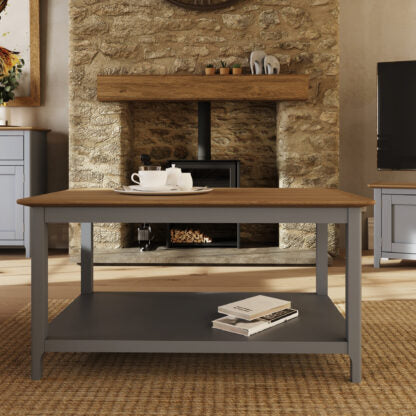 Wooden dining table with a stone fireplace in a living room setting