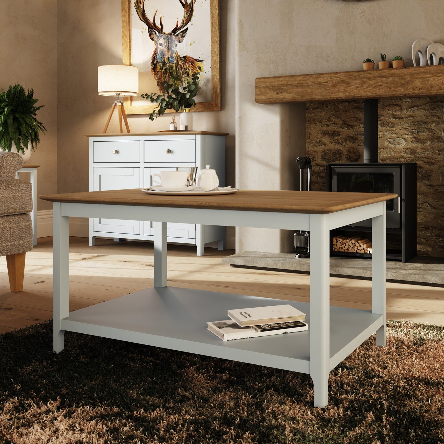 Wooden dining table with a white base in a living room setting.