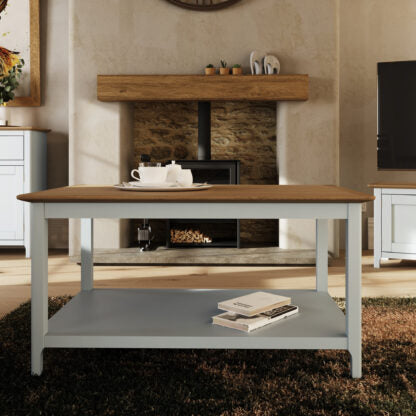 Two-toned table with a wooden top and gray base in a living room setting.