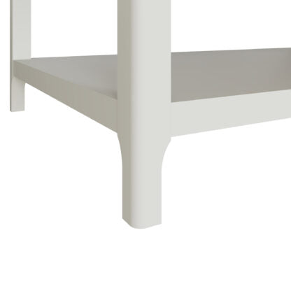 Close-up of a white wooden shelf or bed frame corner with a vertical post and horizontal shelf board on a plain white background.