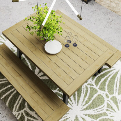 Wooden dining table with bench and decorative items on a patterned rug