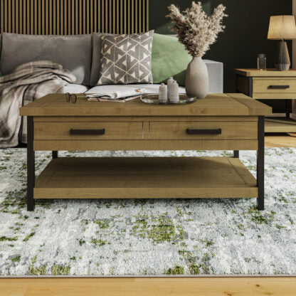 A rustic wooden coffee table with two drawers and a lower shelf, styled in a modern living room.
