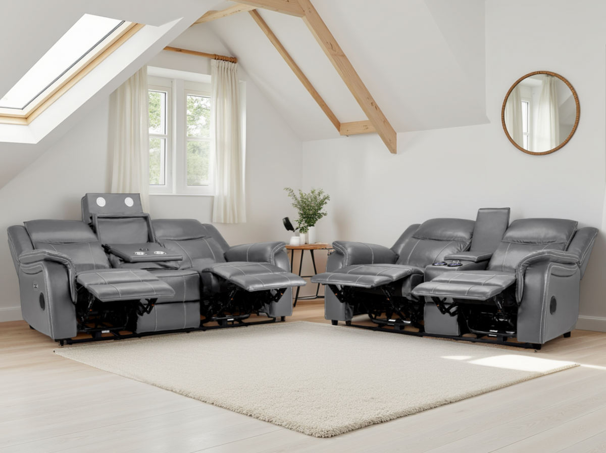 Gray reclining sofa set in a modern living room with wooden beams and large windows.