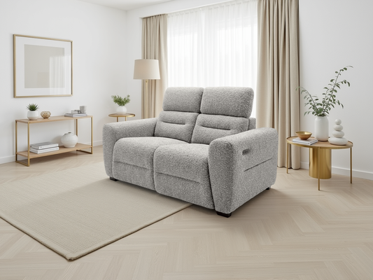 Gray recliner sofa in a modern living room with light wood flooring and neutral decor.