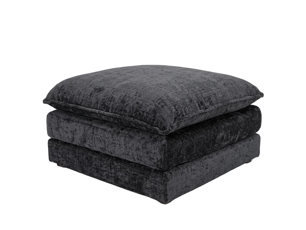 A black crushed velvet ottoman with a square cushion on top, shown against a plain white background.