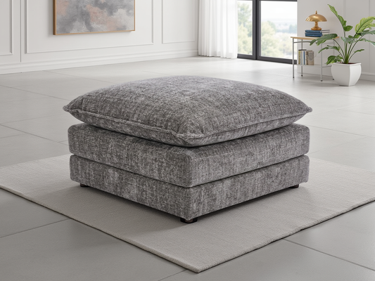 Gray upholstered ottoman in a modern living room setting