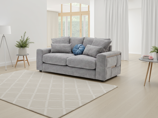 Gray sofa in a modern living room with a rug and decorative items.