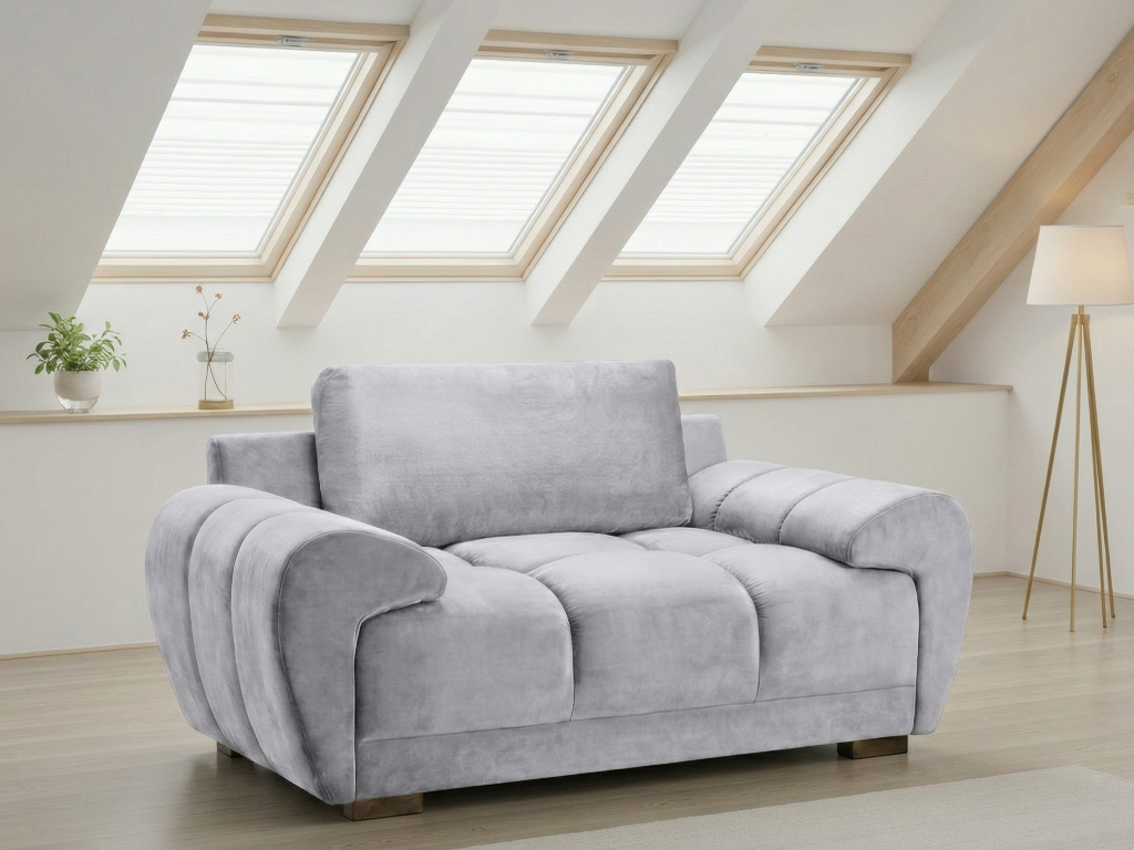 Gray sofa in a room with skylights and a lamp.