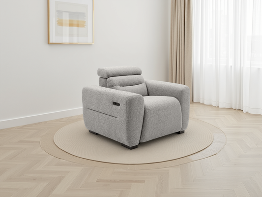 Gray armchair in a room with light-colored walls and flooring
