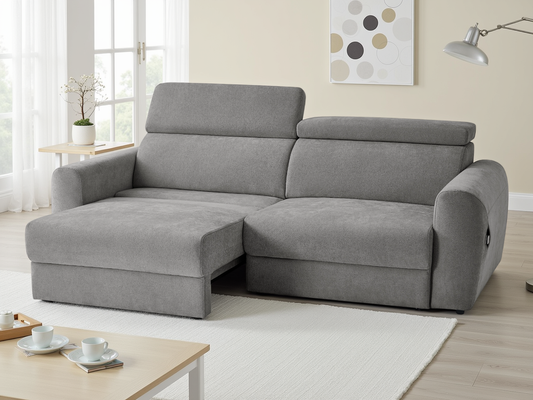 Gray sectional sofa in a living room setting with a coffee table and decor items.