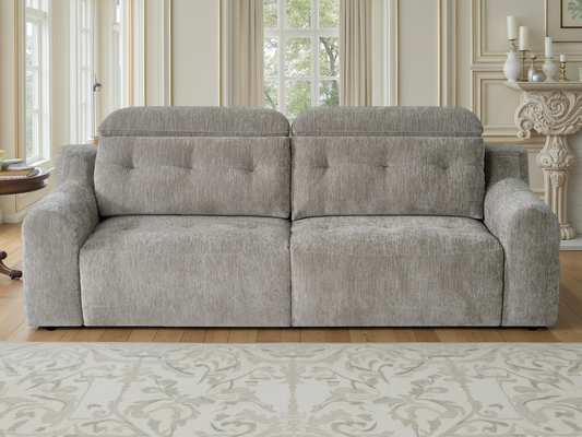 A light gray upholstered loveseat sofa with tufted back cushions, shown in a bright, elegant living room.