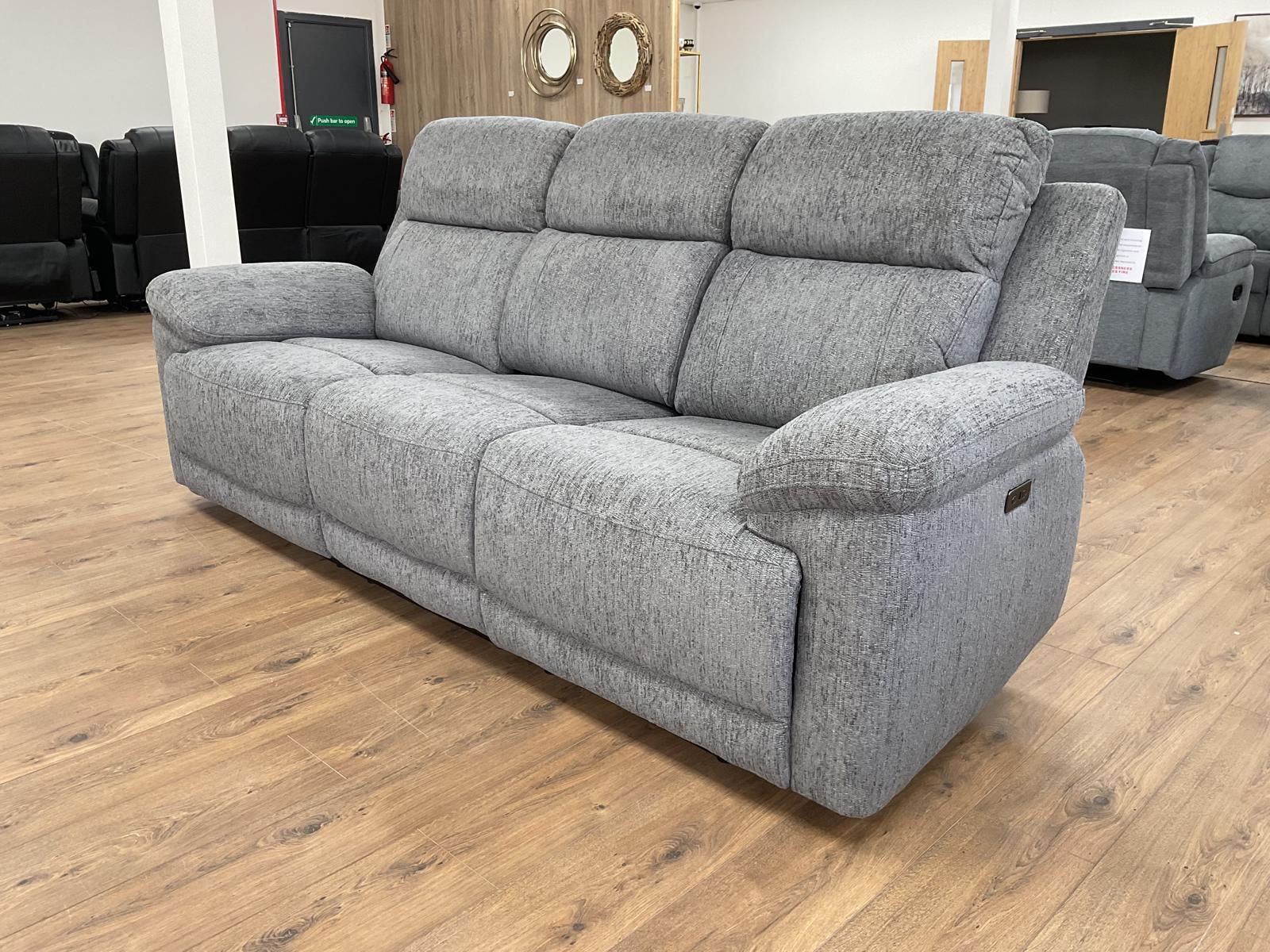 Gray sofa in a showroom setting with wooden flooring