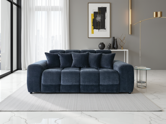 Modern living room with a black sofa, side table, and abstract art on the wall.