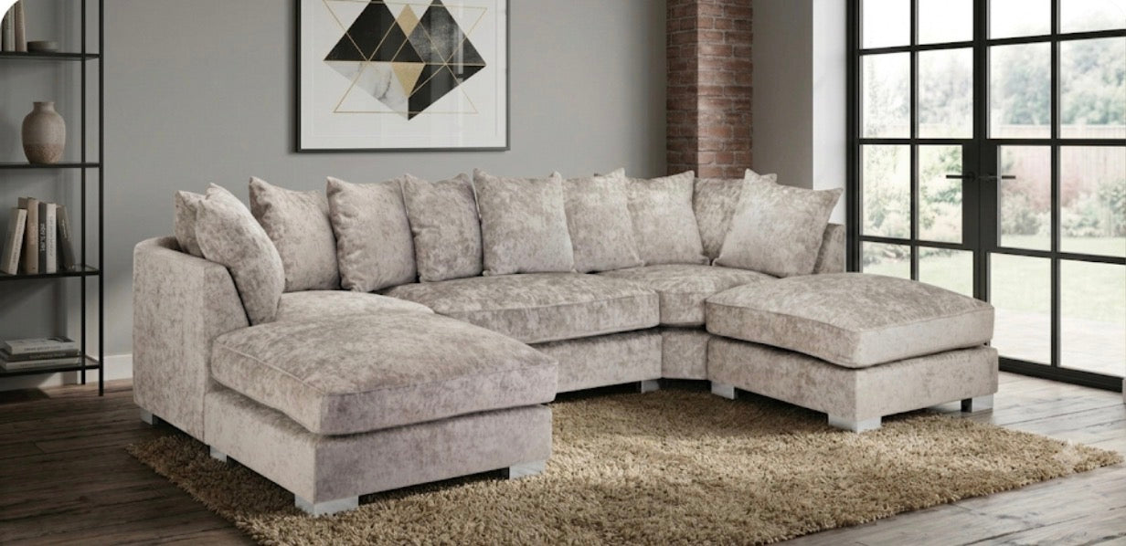 A light beige textured fabric sectional sofa with a left-facing chaise and a right-facing chaise, styled in a modern living room.