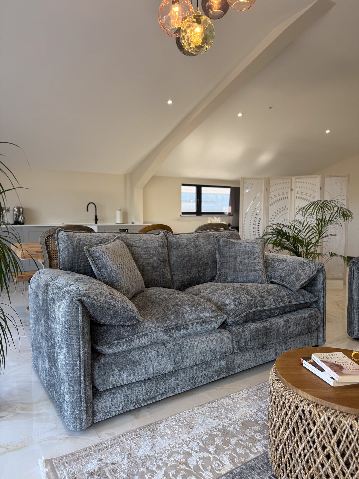 Gray sofa in a living room with a coffee table and decorative elements.