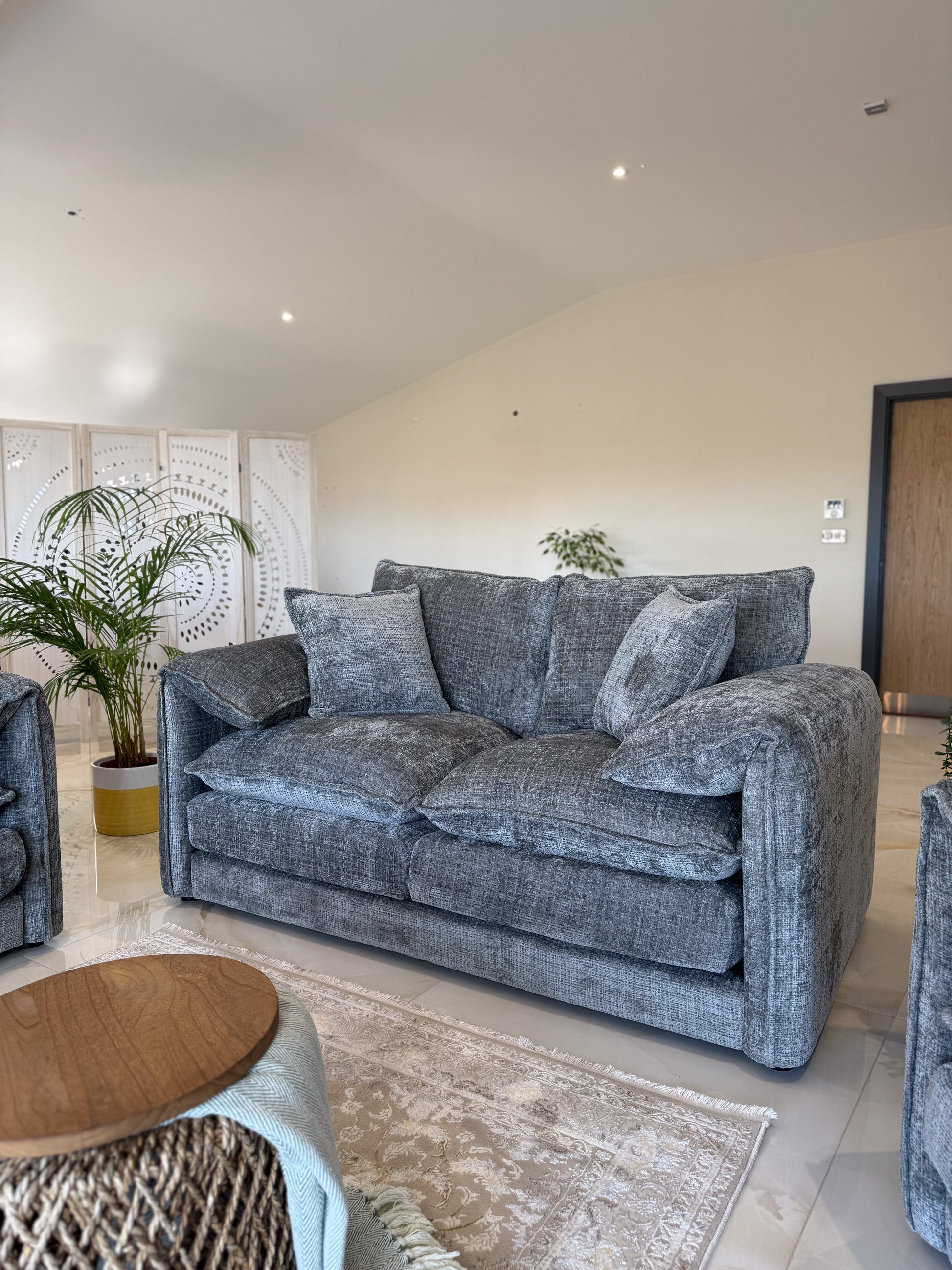 Gray sofa in a living room with a wooden table and decorative elements.