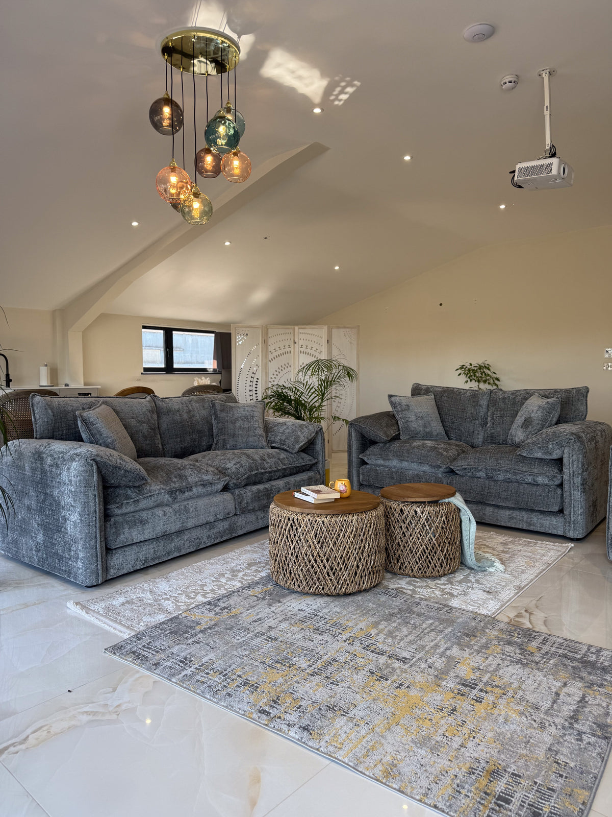 Living room with gray sofas, a coffee table, and decorative elements.
