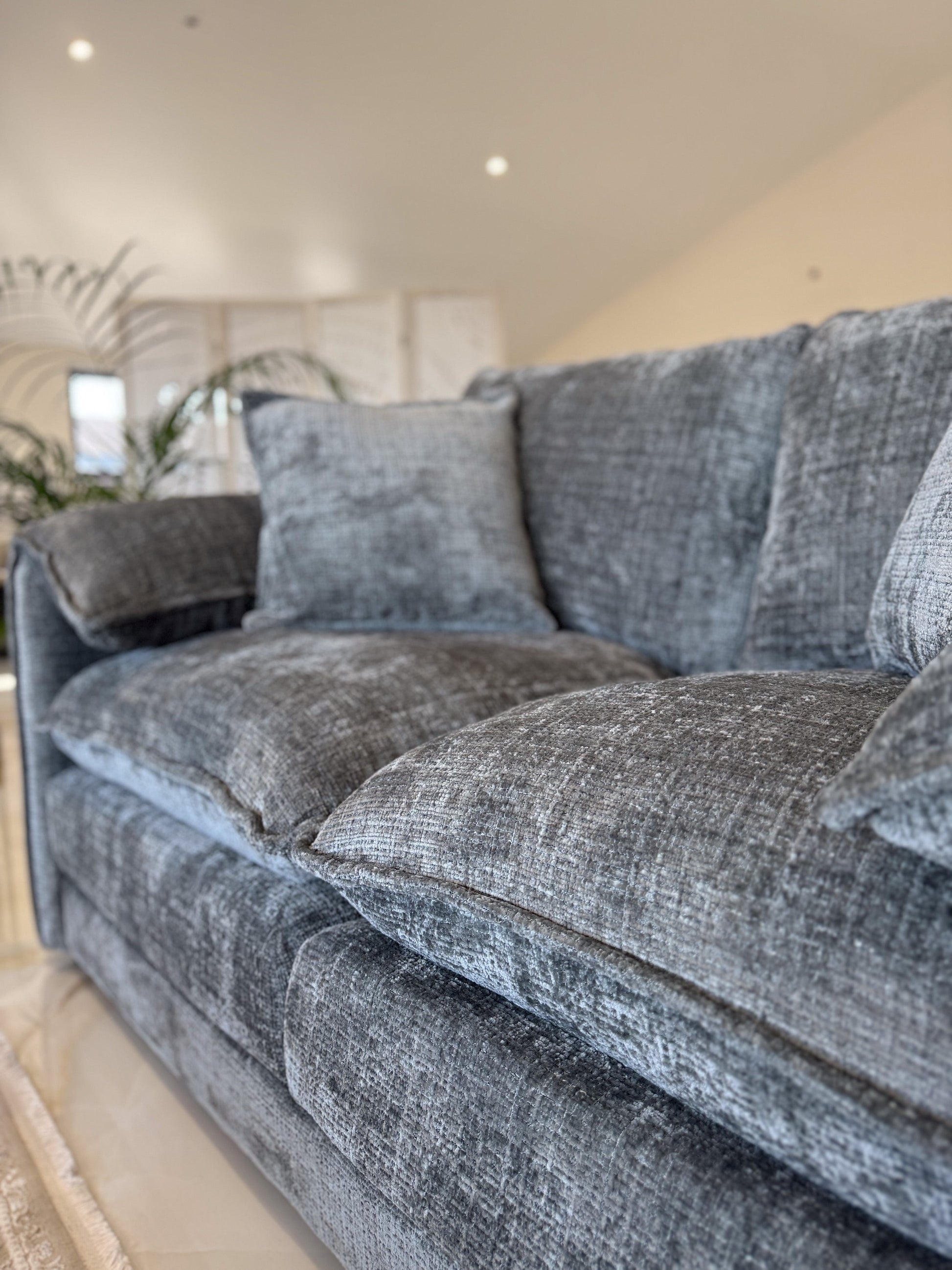 Gray sofa in a living room setting with neutral decor