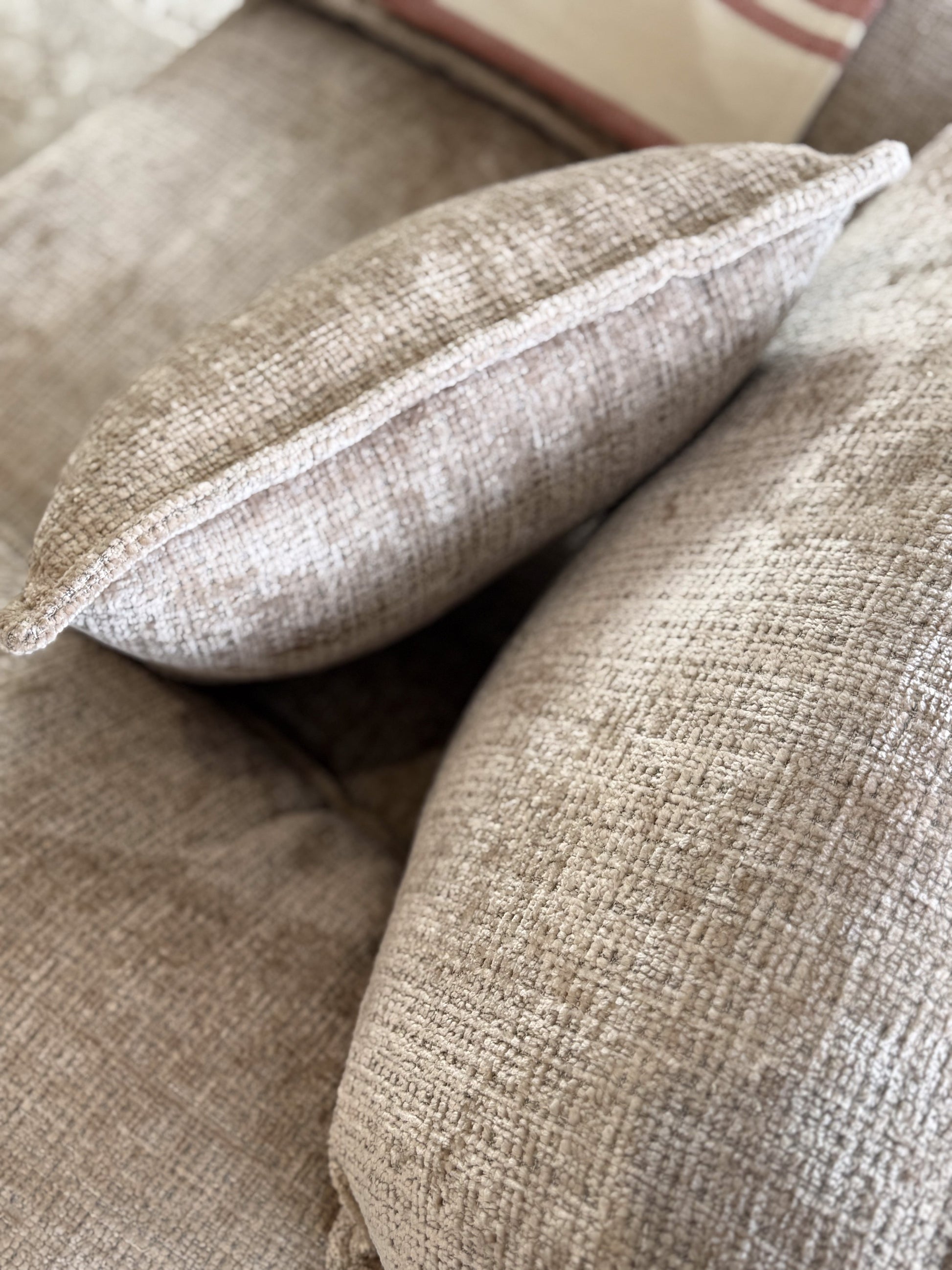 Textured beige pillows on a sofa