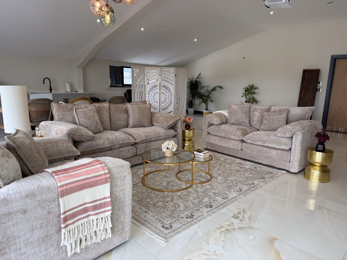 Living room with beige sofa, coffee table, and decorative items.