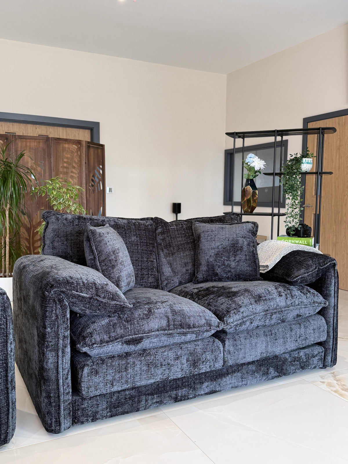 Black sofa in a living room with decorative elements.