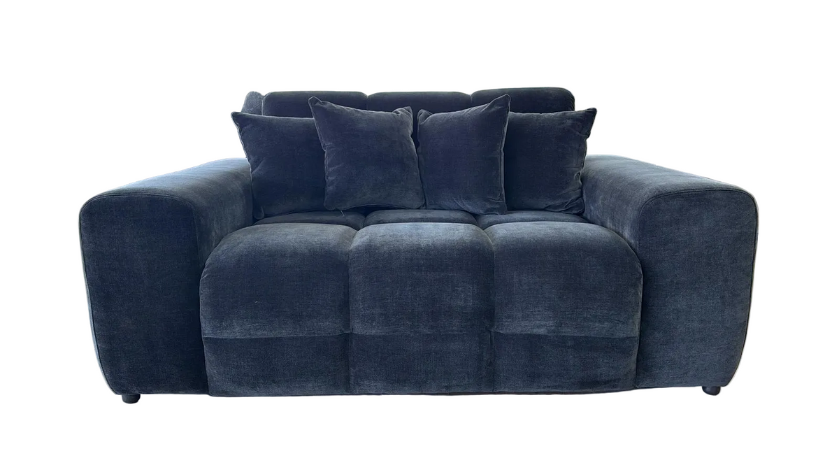 black velvet loveseat sofa with four matching throw pillows, shown against a plain white background.