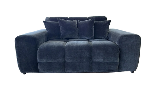 black velvet loveseat sofa with four matching throw pillows, shown against a plain white background.