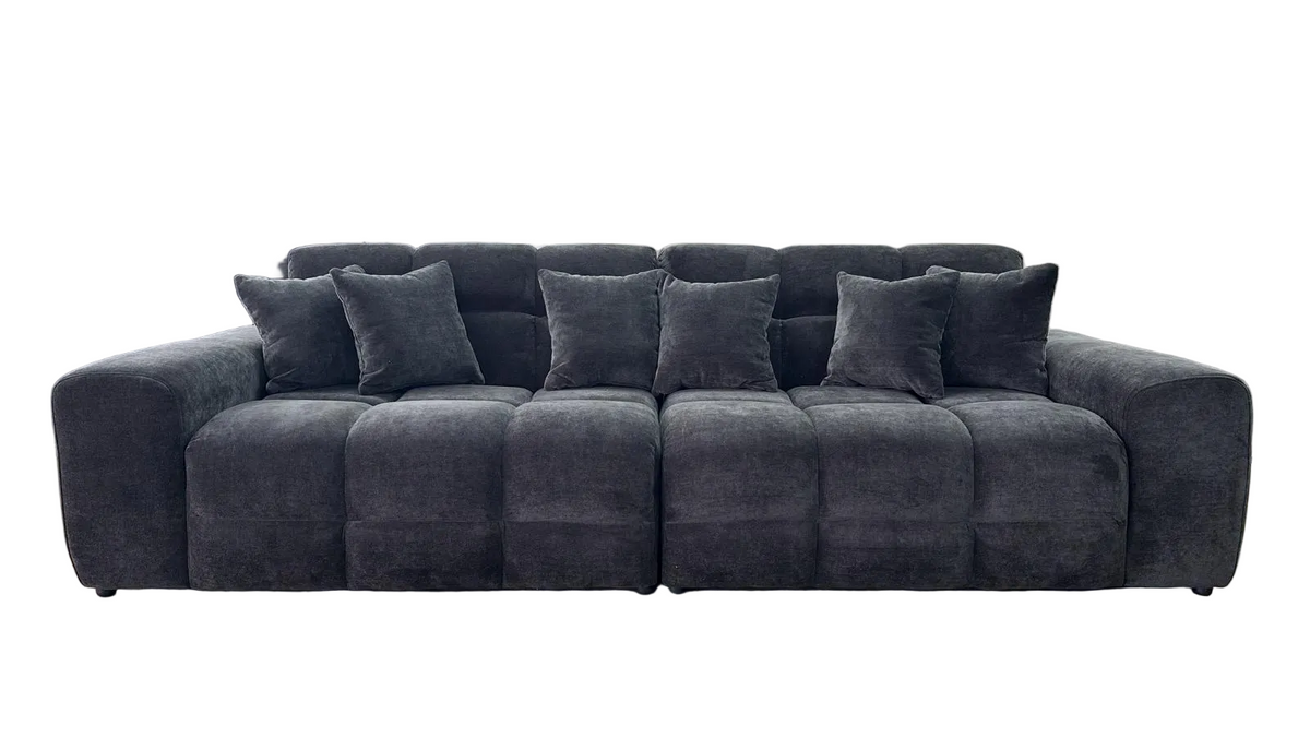 A dark black tufted fabric sofa with matching throw pillows, shown against a plain white background.